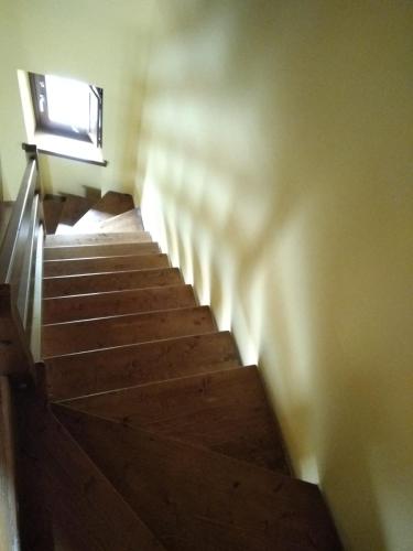 a set of stairs in a room with a window at Botton D' Oro in Cornalba
