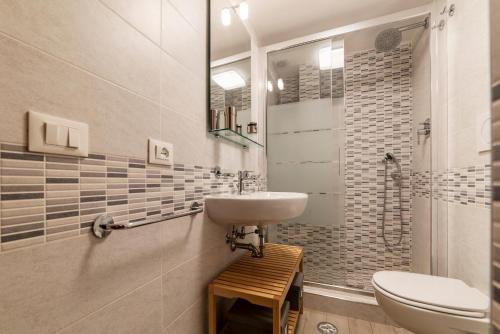 a bathroom with a sink and a toilet at Termini Central and Elegant Apartment in Rome
