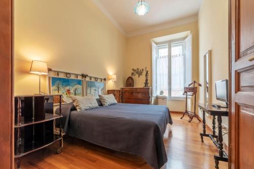 a bedroom with a bed and a television in it at Termini Central and Elegant Apartment in Rome