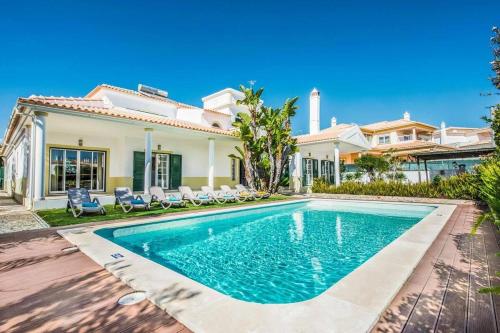 a villa with a swimming pool in front of a house at Villa Mar Ali - JACUZZI - 400m from the beach - BY BEDZY in Albufeira