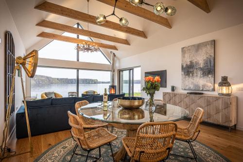 a living room with a glass table and chairs at Tides Uig Isle of Skye in Uig