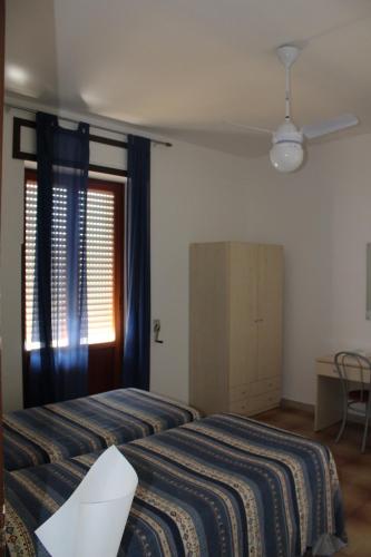 a hotel room with two beds and a window at Il Gabbiano in Otranto