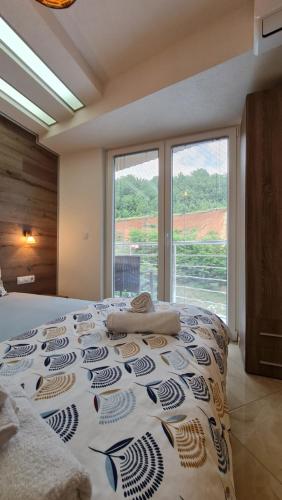 a large bed in a room with a large window at Apartment AXA in Ohrid