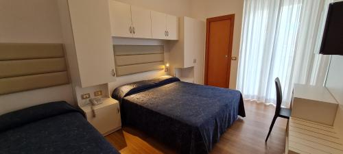 Postel nebo postele na pokoji v ubytování Hotel Atlas