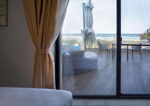 a room with a view of the ocean from a bedroom at Vila Gama in Lozenets
