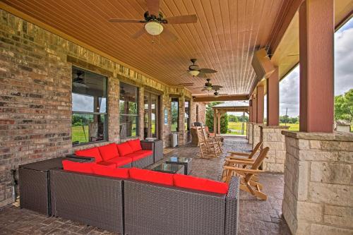 an outdoor patio with a red couch on a house at Blue Ridge Home with Game Room 14 Mi to McKinney! in Blue Ridge