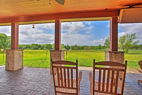 a porch with two chairs and a view of a field at Blue Ridge Home with Game Room 14 Mi to McKinney! in Blue Ridge