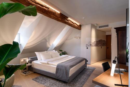 a bedroom with a bed and a desk in a room at Zlata Ladjica Boutique Hotel in Ljubljana