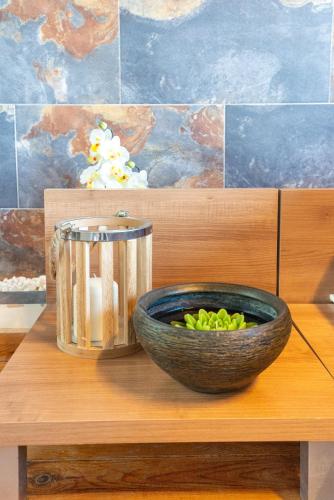 a bowl of green vegetables sitting on a wooden table at Duplex de lujo en la playa , jacuzzy, piscina, chimenea y padel in Benalmádena
