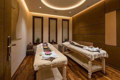 two hospital beds in a room with at Mala Garden Design Hotel in Siófok