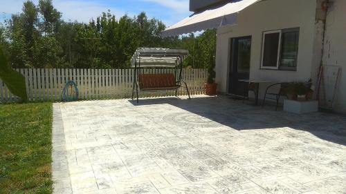 a patio with a bench and a table in a yard at apartment in a country house# in Kalamata