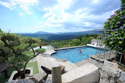 a swimming pool with a view of the mountains at A Fontana in Zonza