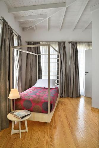 a bedroom with a canopy bed and a table at VESTA - Heliopolis Residence in Cairo
