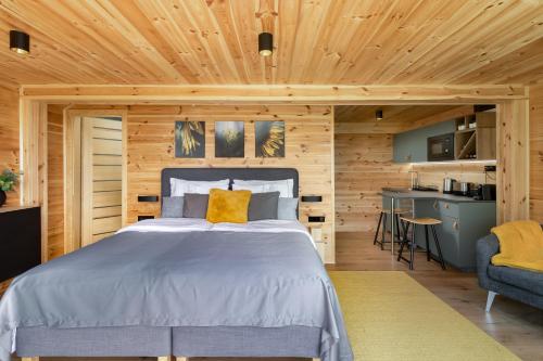 a bedroom with a bed in a wooden room at Szarvashegy Panoráma Apartman in Szentendre