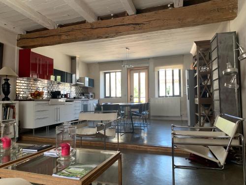 a large kitchen and dining room with a table and chairs at Maison Face au Soleil in Le Bois-Plage-en-Ré