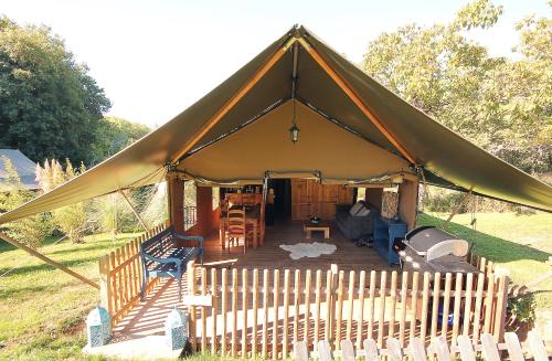 a large tent with a deck in a yard at Pagel in Catus