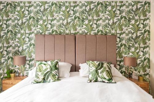 a bed with white sheets and pillows in a bedroom at The Fromeway in Radstock