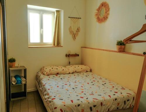 a bedroom with a bed and a window at New! Cosy T2 au coeur de la ville - climatisation - coin terrasse in Aix-en-Provence