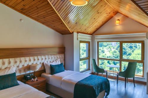 a bedroom with two beds and a large window at Amasra Diamond Hotel in Amasra