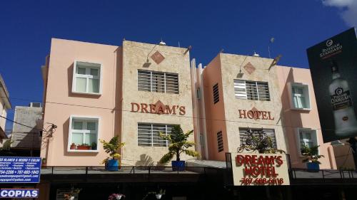 a pink building with signs on the side of it at Dreams Hotel Puerto Rico in San Juan