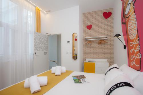 a room with a bed and a brick wall at Casual Socarrat Valencia - Adults Only in Valencia