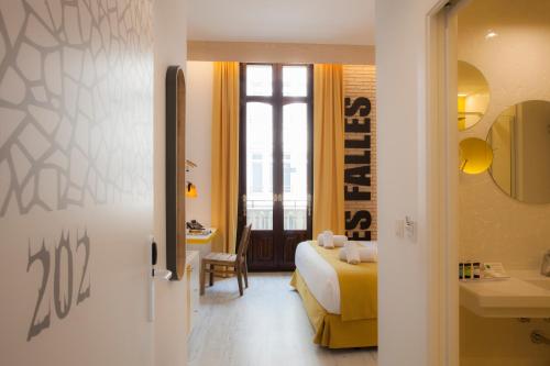 a hotel room with a bed and a bathroom at Casual Socarrat Valencia - Adults Only in Valencia