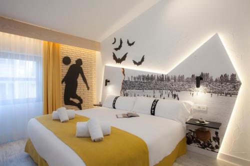 a bedroom with a large bed with a poster of a beach at Casual Socarrat Valencia - Adults Only in Valencia