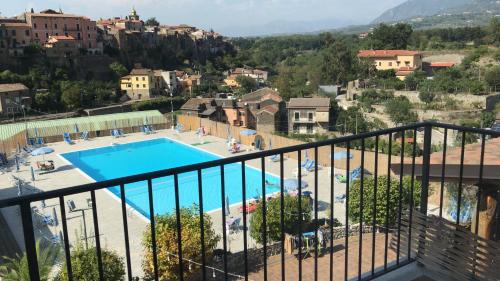 a view of a swimming pool from a balcony at Le Rocce in SantʼAgata deʼ Goti