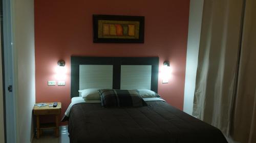 a bedroom with a large bed with red walls at Dreams Hotel Puerto Rico in San Juan