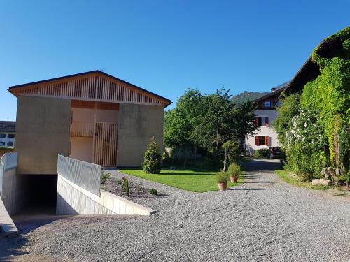 a house with a driveway leading to a building at Lahnhof in Lana