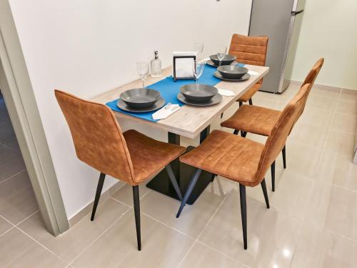 a dining room table with chairs and a blue table cloth at Epipleon Luxury Suites - 107 - Διαμέρισμα 85τμ - Θέα στη θάλασσα in Nafpaktos