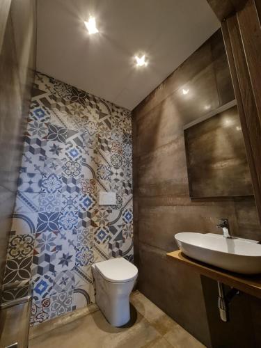 a bathroom with a toilet and a sink at Il Vascello in Porto Cesareo