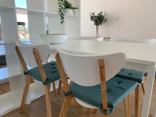 a dining room with a white table and chairs at Strandcabane in Nieuwpoort