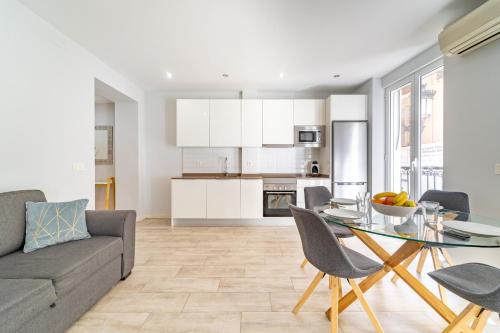 a living room with a couch and a glass table at MyFlats SF 54 in Alicante