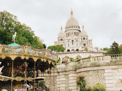 a carnival ride in front of a building at Hotel Bellevue Montmartre in Paris