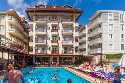 a hotel with a swimming pool in front of a building at Oba Time Hotel in Alanya