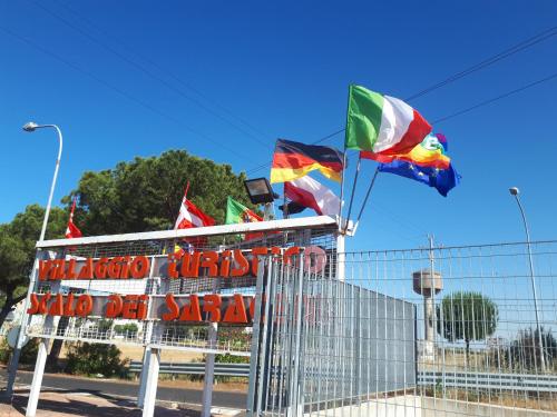 a group of flags on top of a building at La terrazza sul MARE Manfredonia in Manfredonia