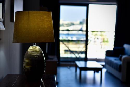 a lamp sitting on a table in a living room at Shore Bridge in Il-Gżira