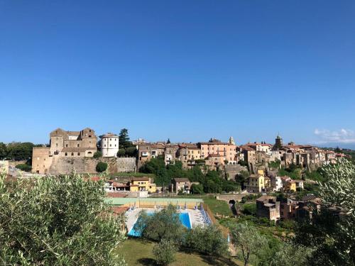 a town on a hill with a castle at Le Rocce in SantʼAgata deʼ Goti