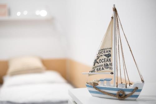 a toy boat sitting on a table next to a bed at Apartments Nautilus, nearby beach Svetilnik in Izola