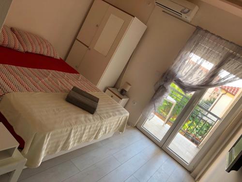 a bedroom with a bed and a sliding glass door at Guesthouse Adriatic in Biograd na Moru