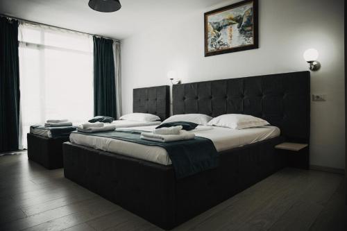 a bedroom with two large beds in a room at Vila La Faleza Dubova in Dubova