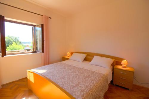 a small bedroom with a bed and a window at Apartment Liliana near beach in Poreč