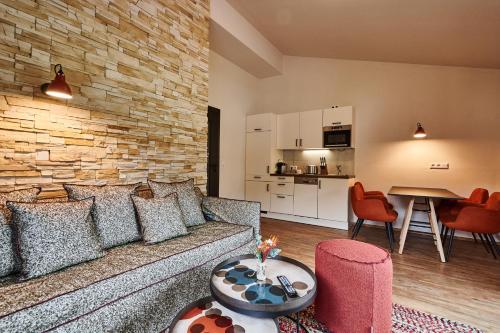 a living room with a couch and a table at EVI APARTMENTS via we rent in Kaprun