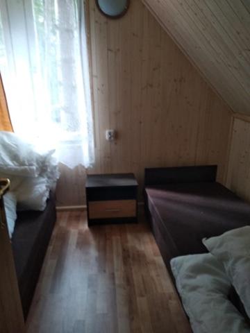 a small room with two beds and a window at Oleandria- ,, Domek Malinka" nr 35 in Biskupiec