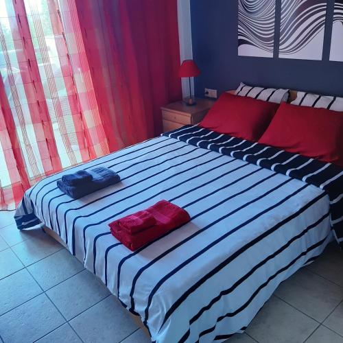 a bedroom with a large bed with two pillows on it at Magic Mola in Mola Kalyva