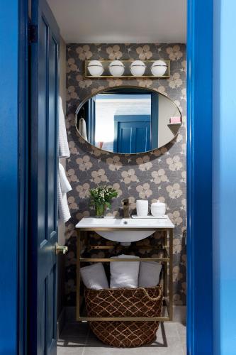 a bathroom with a sink and a mirror at The Cornell Inn, Lenox & The Berkshires in Lenox