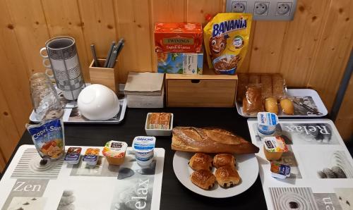 a table with a bunch of breakfast foods on it at Chambre d'hôte chez Nathalie & Roland in Massiac