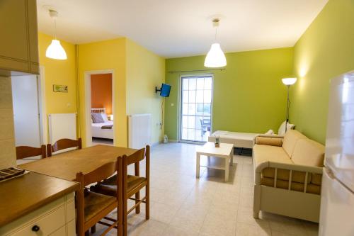 a kitchen and living room with a couch and a table at Elaionas in Leonidion