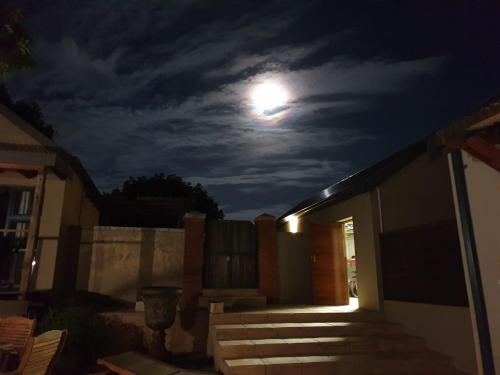 a full moon in the sky over a house at Relaxation in KwaDukuza